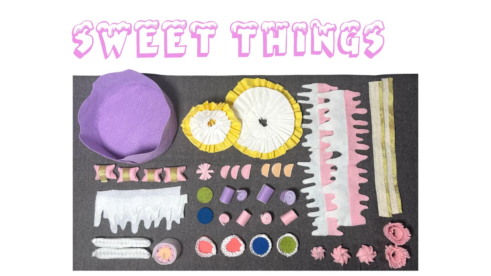 Overhead photograph of the complete soft-toy set, including cake bases, fabric icing strips, ruffles and small decorations.