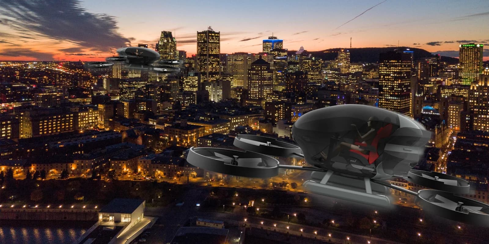 Two rendered passenger drones composited over a city skyline at dusk.